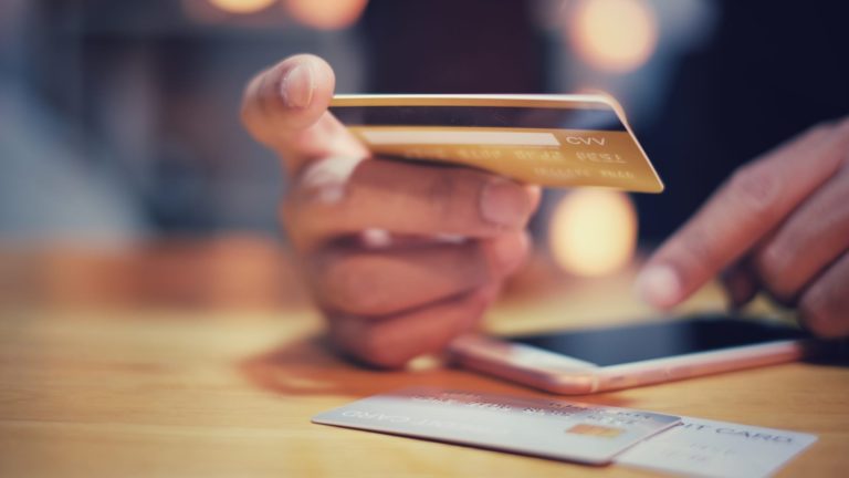 Bank card balances spike after stimulus checks helped cut back debt