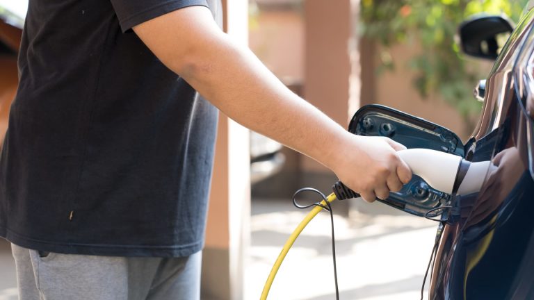 To spend money on automobiles or charging factors first